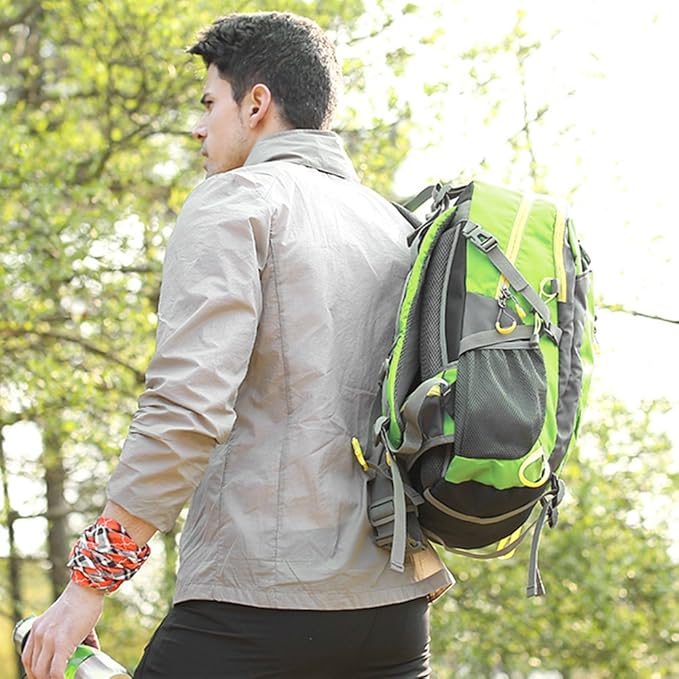 Man wearing a green 40 liter backpack walking through forest – outdoor lifestyle scene